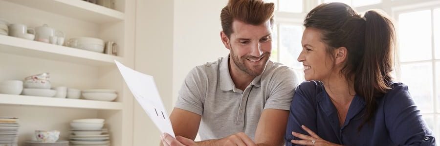 Smiling couple looking at finances | Financial Information | Tiger Finance