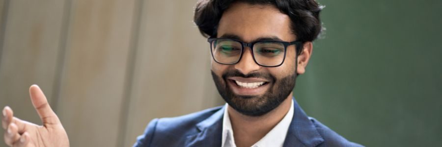 happy-indian-business-man-looking-at-laptop-feelin-caveat-loans-tiger-finance
