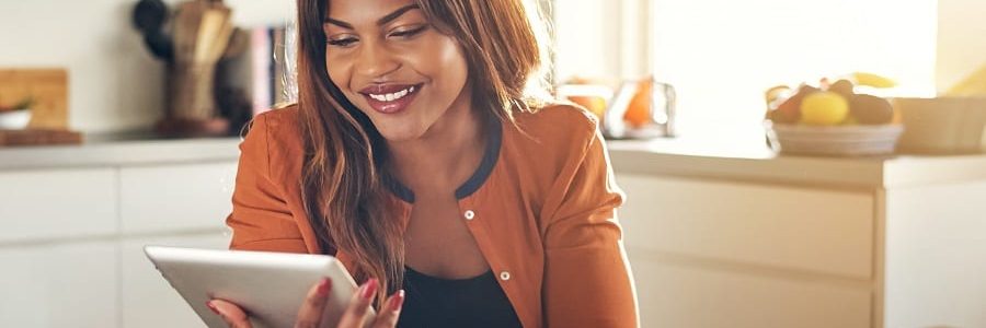 Smiling Self-Employed Woman Using A tablet | Financial Information | Tiger Finance